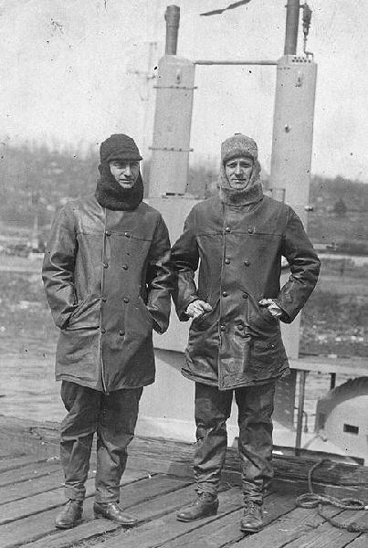 G-4's officers standing beside their submarine, at Submarine Base New London, CT. in 1917. They are Lieutenant (Junior Grade) William F. Callaway (Executive Officer), at left, and Lieutenant (Junior Grade) Paul F. Foster (Commanding Officer).