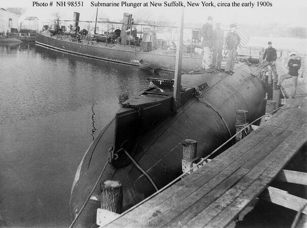 Plunger at the pier in New Suffolk, circa 1901. The USS Winslow (Torpedo Boat No. 5) is moored in the background.